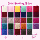 A color chart titled 'Distinct Palette of 29 Hues' showing a grid of 29 yarn color swatches for Woolen Wonders yarn in many different colors on a light pink background with decorative pink icons.