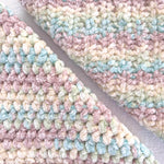 KnitPal Chenillique XL chenille yarn in Beach Sand, close-up swatch half knit half crochet showing plush pastel texture.