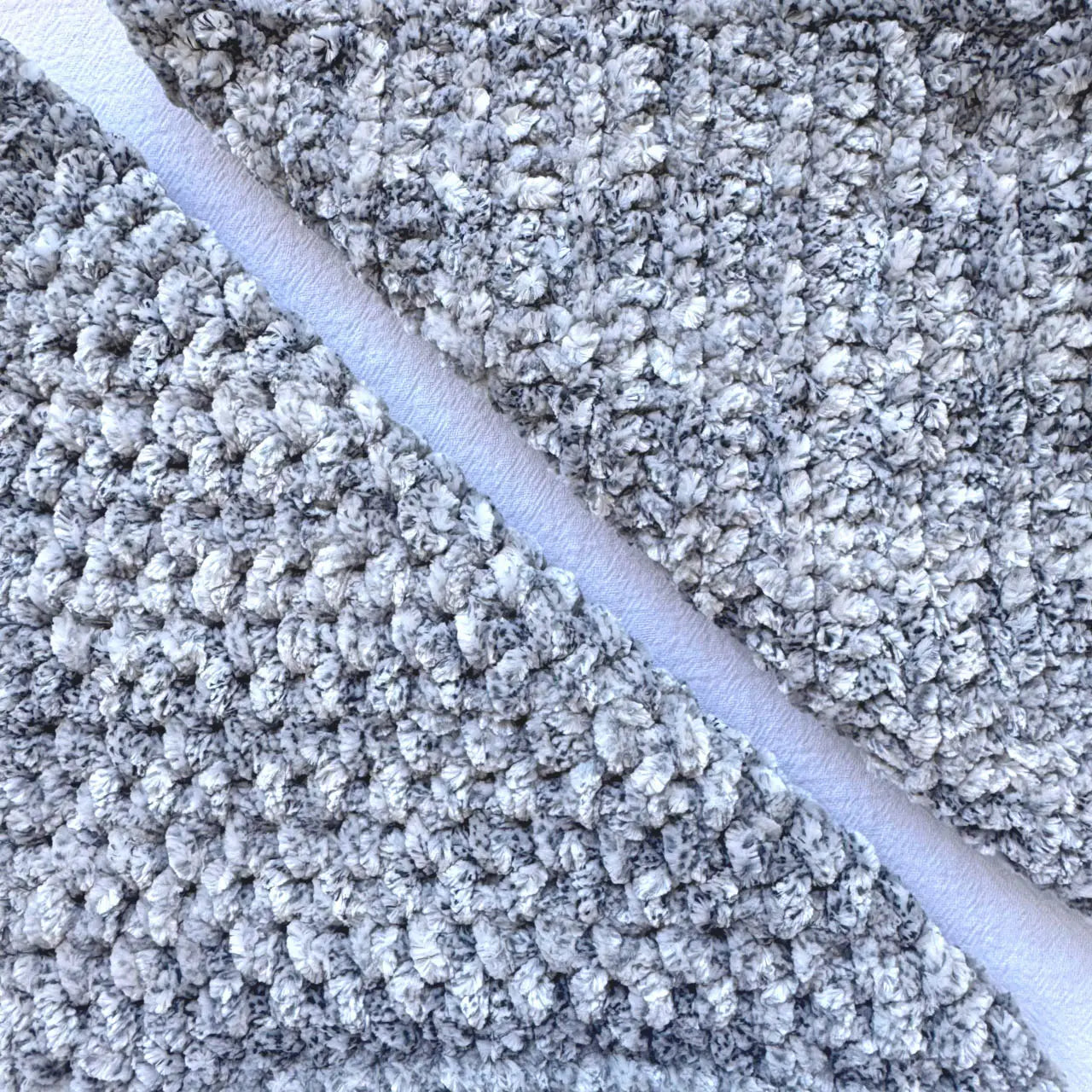 KnitPal Chenillique XL chenille yarn in Clouded Ink, close-up swatch half knit half crochet showing plush gray-and-white texture.