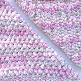 KnitPal Chenillique XL chenille yarn in Dusky Rose, close-up swatch half knit half crochet showing plush pink-and-gray texture.