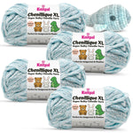 KnitPal Chenillique XL super bulky chenille yarn in Ocean Mist blue and white colorway, four skeins with crochet whale plushie.