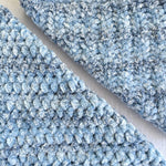 KnitPal Chenillique XL chenille yarn in Ocean Mist, close-up swatch half knit half crochet showing plush blue-and-white texture.