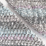 KnitPal Chenillique XL chenille yarn in Orchid Mist, close-up swatch half knit half crochet showing plush gray, blue, and lilac texture