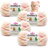 KnitPal Chenillique XL super bulky chenille yarn in Peach Fizz pink, peach, and cream colorway, four skeins with crochet bear plushie.