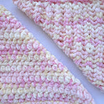 KnitPal Chenillique XL chenille yarn in Peach Fizz, close-up swatch half knit half crochet showing plush pink, peach, and cream texture.