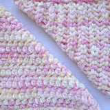 KnitPal Chenillique XL chenille yarn in Peach Fizz, close-up swatch half knit half crochet showing plush pink, peach, and cream texture.