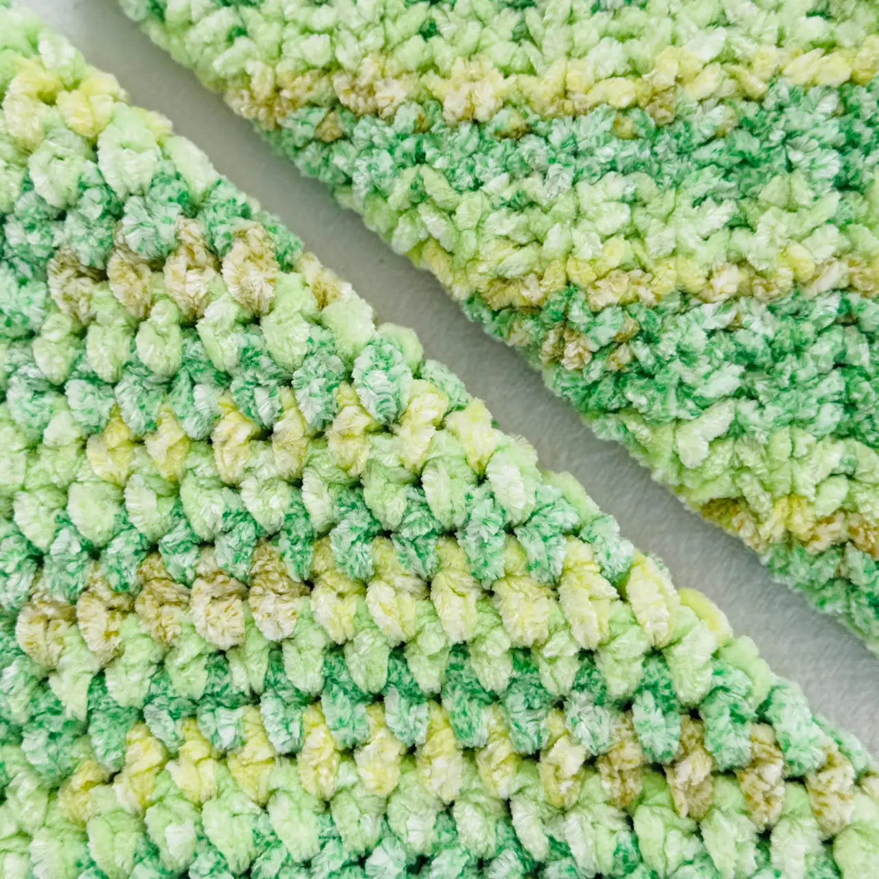 KnitPal Chenillique XL chenille yarn in Spring Green, close-up swatch half knit half crochet showing plush green and yellow texture.