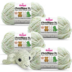 KnitPal Chenillique XL super bulky chenille yarn in Spring Haze cream and green speckled colorway, four skeins with crochet elephant plushie.