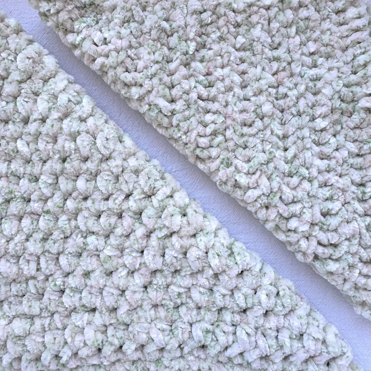 KnitPal Chenillique XL chenille yarn in Spring Haze, close-up swatch half knit half crochet showing plush cream and green speckled texture.