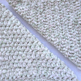 KnitPal Chenillique XL chenille yarn in Spring Haze, close-up swatch half knit half crochet showing plush cream and green speckled texture.