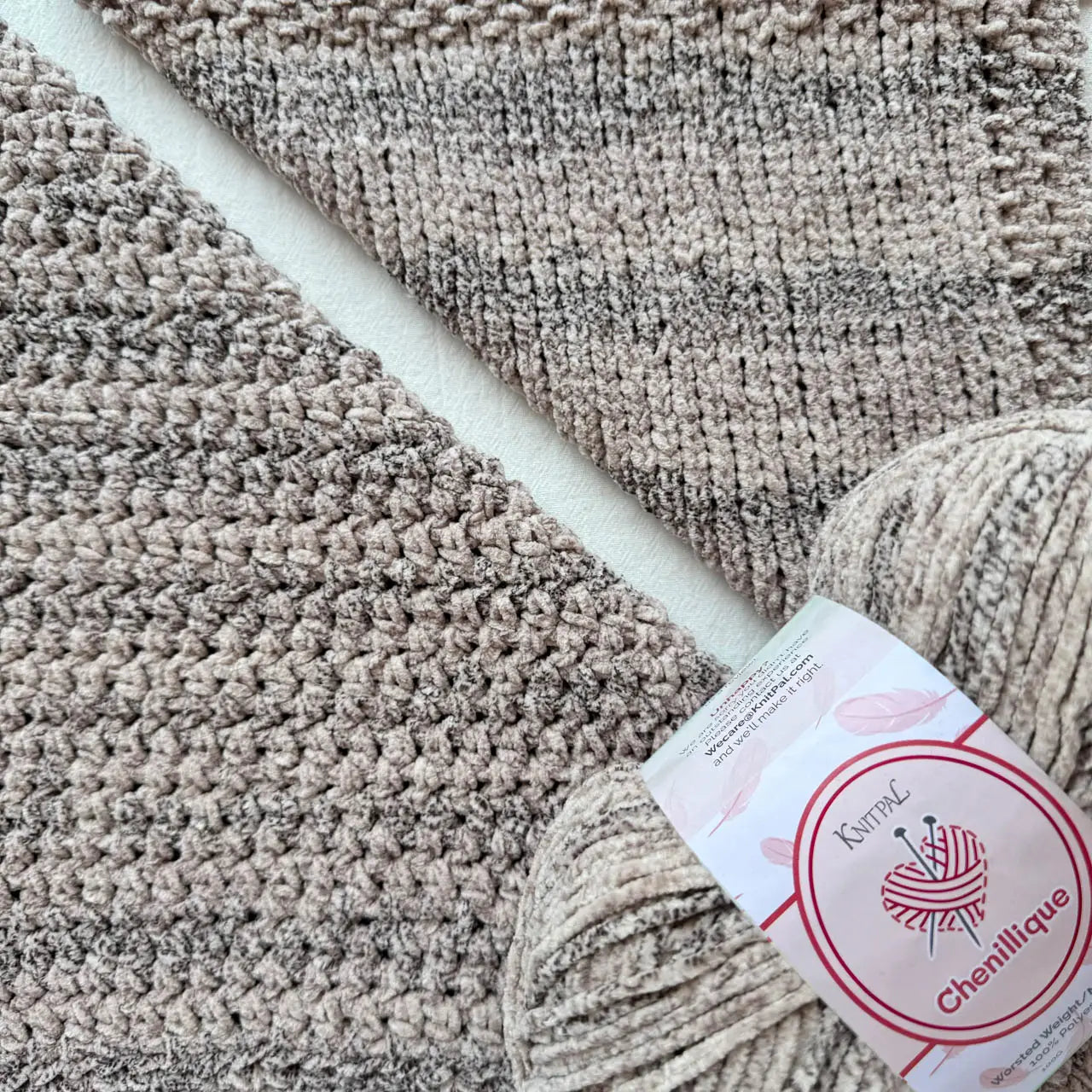 KnitPal Chenillique Cub Brown chenille yarn swatch showing knit and crochet texture side by side in warm taupe with dark flecks