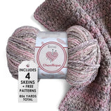 KnitPal Chenillique yarn in Enchanted Berry colorway, worsted weight 100% polyester chenille cake with label, styled with knitted swatch