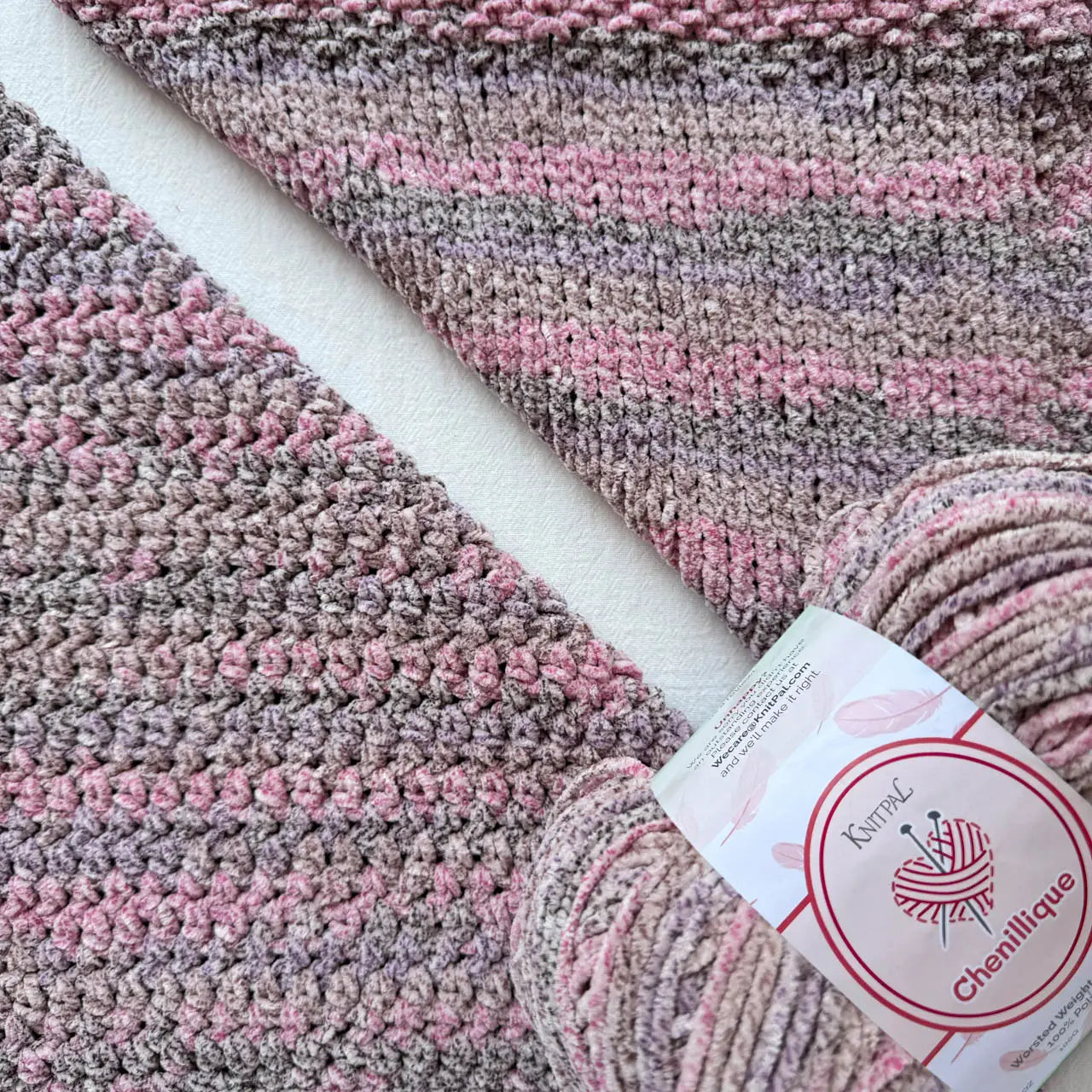 KnitPal Chenillique Enchanted Berry chenille yarn swatch showing knit and crochet texture side by side in mauve, rose, and dark flecks