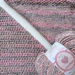 KnitPal Chenillique Enchanted Berry chenille yarn swatch showing knit and crochet texture side by side in mauve, rose, and dark flecks