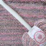 KnitPal Chenillique Enchanted Berry chenille yarn swatch showing knit and crochet texture side by side in mauve, rose, and dark flecks