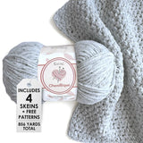 KnitPal Chenillique yarn in Frosted Blue colorway, worsted weight 100% polyester chenille cake with label, styled with knitted swatch