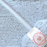 KnitPal Chenillique Frosted Blue chenille yarn swatch showing knit and crochet texture side by side in soft icy silver-blue