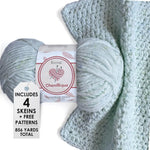 KnitPal Chenillique yarn in Icy Mint colorway, worsted weight 100% polyester chenille cake with label, styled with knitted swatch