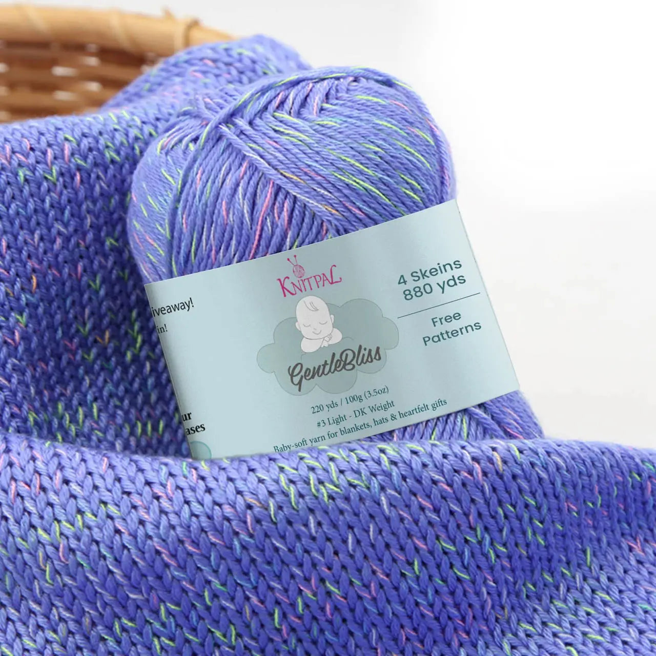 KnitPal GentleBliss DK weight yarn in periwinkle violet with multicolor marl flecks, skein on knitted fabric swatch, label visible