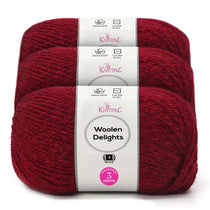Three skeins of Knitpal Woolen Delights yarn in a rich burgundy red color, bundled together with a white paper label showing product details.