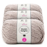 Three skeins of Knitpal Woolen Delights yarn stacked vertically, showing the light heathered taupe color and white paper labels with pink and gray branding.
